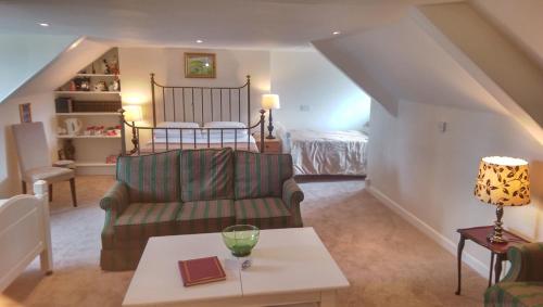 a living room with a couch and a bed at The Globe Inn in Chagford