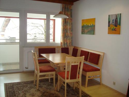 a dining room with a wooden table and chairs at Gästehaus-Pension Bendler in Kirchdorf in Tirol