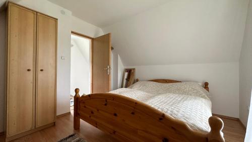 a bedroom with a wooden bed and a wooden cabinet at B&B Hills Bihać in Bihać