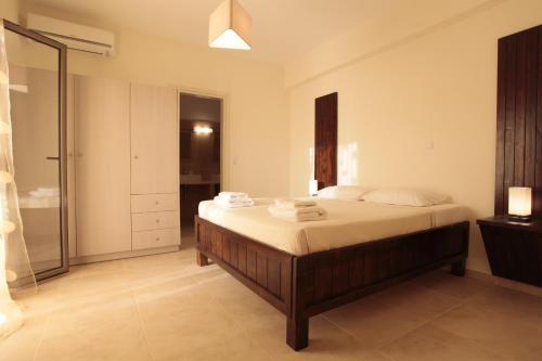 a bedroom with a bed and a walk in shower at Asterias in Skiros
