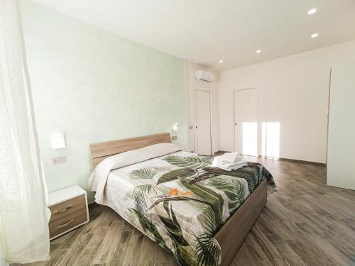 a bedroom with a large bed and a wooden floor at La dolce vita in Agerola