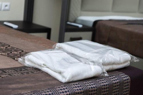 two white bags sitting on top of a table at Hôtel Bachou in Dakar