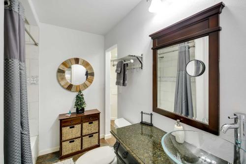 a bathroom with a tub and a sink and a mirror at Lakefront Haven Near Oaklawn and Casino Resort! in Hot Springs
