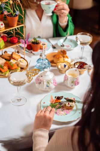 a group of people sitting at a table with food at Taj 51 Buckingham Gate Suites and Residences in London