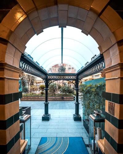 an arched entryway to a building with a ceiling at Taj 51 Buckingham Gate Suites and Residences in London