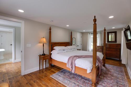a bedroom with a canopy bed and a rug at Historic Erwinna Vacation Home Near Delaware River in Point Pleasant