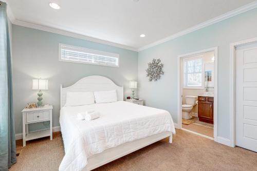 a bedroom with a white bed and a bathroom at Town of Rehoboth Beach 302 Laurel St in Rehoboth Beach