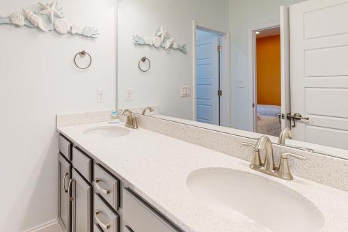 a bathroom with two sinks and a large mirror at Town of Rehoboth Beach 302 Laurel St in Rehoboth Beach
