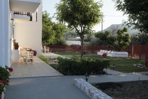 a view of a yard with a house and a patio at Asterias in Skiros