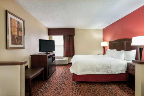 a hotel room with a bed and a flat screen tv at Hampton Inn Abilene in Abilene