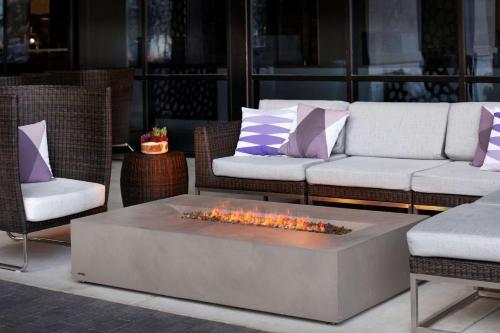 a patio with two couches and a fire pit at Embassy Suites Amarillo Downtown in Amarillo