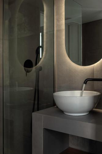 a bathroom with a sink and a mirror at Soleil boutique house with terrace in Rethymno Town
