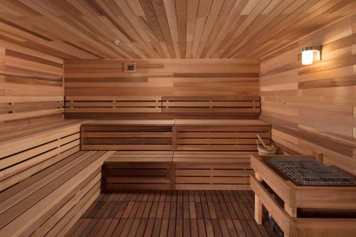 a wooden sauna with a bench and a table at Embassy Suites Amarillo Downtown in Amarillo