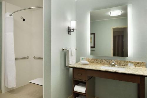 a bathroom with a sink and a large mirror at Homewood Suites by Hilton Kalamazoo-Portage in Kalamazoo