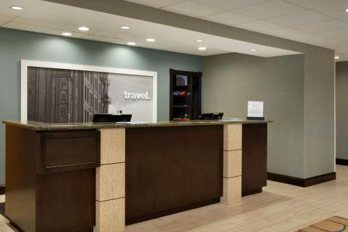 a lobby with a reception counter in a hospital at Hampton Inn & Suites Birmingham Airport Area in Birmingham