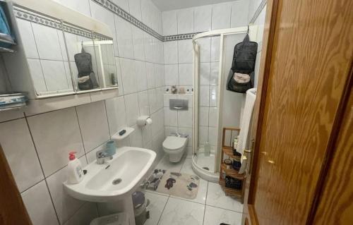 a small bathroom with a sink and a toilet at Costa Calma Apartment OASIS in Costa Calma