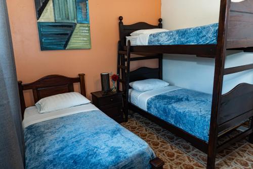 a room with two bunk beds in a room at Stone Cabins Boquete in Boquete