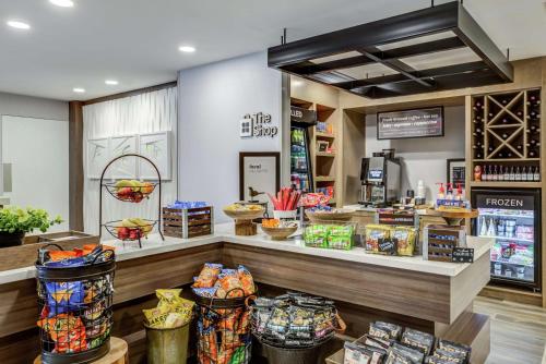 a grocery store with a counter with food at Hilton Garden Inn Boston Waltham in Waltham