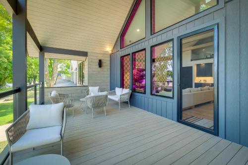 a porch with chairs and a table on a house at Spacious Michigan Home about 6 Mi to Boyne Mountain! in Boyne City
