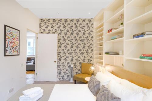 a living room with a white bed and shelves at Central 2Bed Apartment near Barbican & Farringdon FREE WIFI by City Stay Aparts London in London