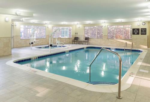 a swimming pool in a hotel room with a pool at Homewood Suites by Hilton Akron/Fairlawn in Akron
