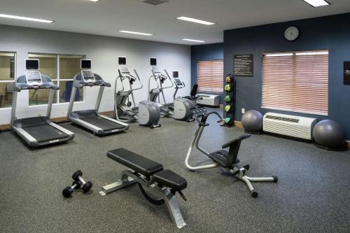 a gym with several treadmills and exercise bikes at Homewood Suites by Hilton Cedar Rapids-North in Cedar Rapids