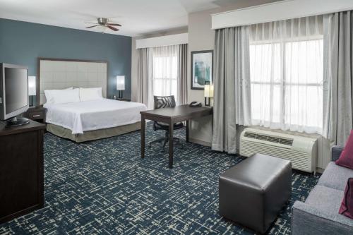 a hotel room with a bed and a desk at Homewood Suites by Hilton Cedar Rapids-North in Cedar Rapids