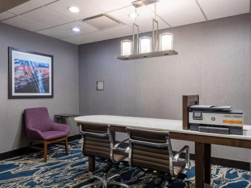 a conference room with a table and chairs at Homewood Suites by Hilton Cedar Rapids-North in Cedar Rapids