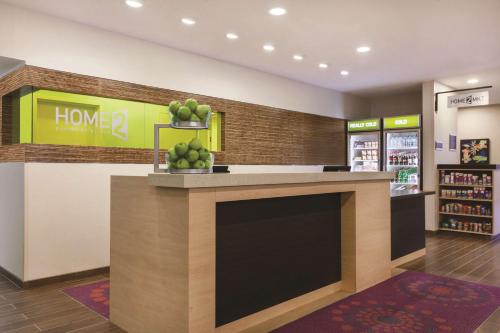 a store with a counter with fruit on it at Home2 Suites by Hilton College Station in College Station