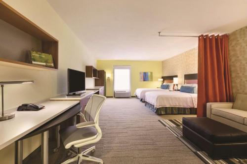 a hotel room with a bed and a desk at Home2 Suites by Hilton College Station in College Station