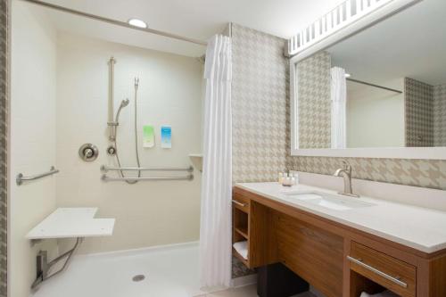 a bathroom with a sink and a shower at Home2 Suites Charlotte I-77 South in Charlotte