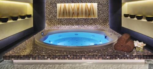 a bathroom with a jacuzzi tub in a room at Квартира студия Damac Maison Cour Jardin in Dubai