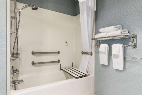 a bathroom with a bath tub and towels at Homewood Suites by Hilton Columbus-Hilliard in Hilliard