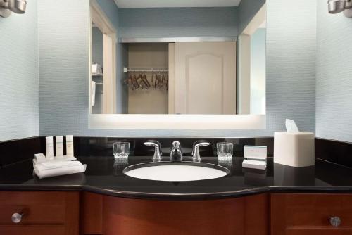 a bathroom with a sink and a mirror at Homewood Suites by Hilton Columbus-Hilliard in Hilliard