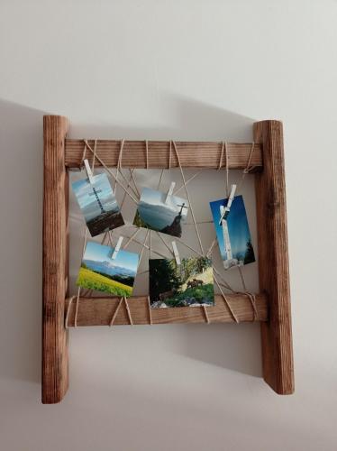 a wooden shelf hanging on a wall with pictures at Rittertal-Altholzseeblick in Altmünster