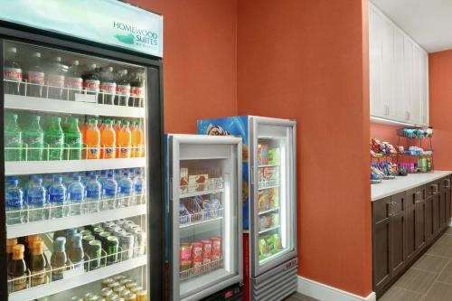 two refrigerators are in a store with drinks at Addison Suites in Addison
