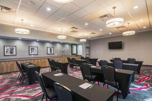 a conference room with tables and chairs and a screen at Hampton Inn & Suites-Dallas/Richardson in Richardson