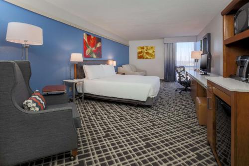 a hotel room with a bed and a desk at Hilton Garden Inn Dallas/Market Center in Dallas