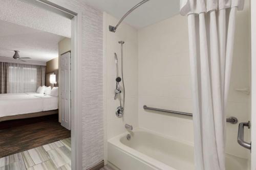 a bathroom with a shower and a bath tub at Homewood Suites by Hilton Dallas-Plano in Plano