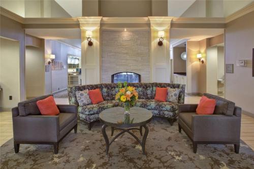 a living room with a couch and two chairs and a table at Homewood Suites by Hilton Dayton South in Miamisburg