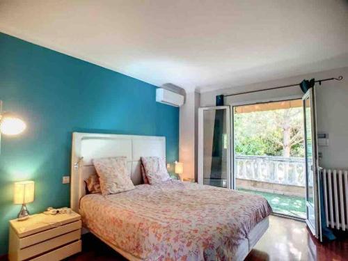 une chambre avec un lit et une grande fenêtre dans l'établissement Superb Villa, swimming pool, secluded gardens, à Cannes