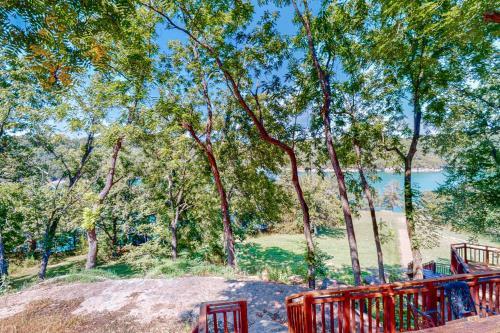 a red fence in a park with a body of water at Lost Rock in Rogers