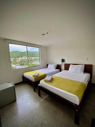 Postel nebo postele na pokoji v ubytování HOTEL RIVERA CENTRAL