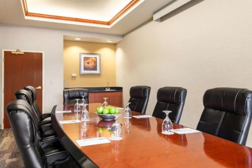 a conference room with a wooden table and black chairs at Hampton Inn & Suites Denver-Cherry Creek in Denver