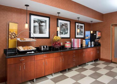 a kitchen with a counter with food on it at Hampton Inn Denver - Northwest Westminster in Westminster