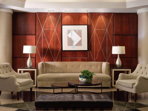 a living room with a couch and two chairs at Hilton Arlington in Arlington
