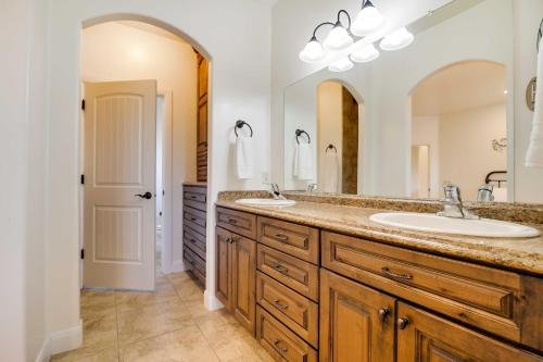 a bathroom with two sinks and a large mirror at Horseshoe Bend Retreat with Fire Pit, Patio and Mtn Views in Page