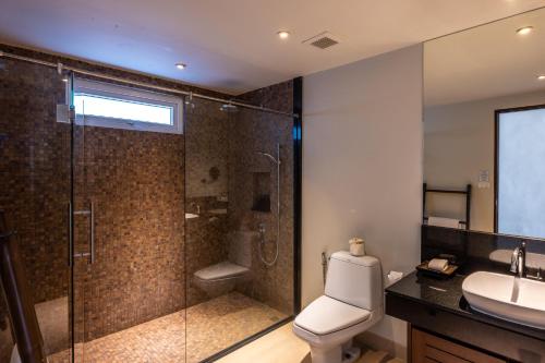 a bathroom with a shower and a toilet and a sink at Selina Serenity Rawai Phuket in Rawai Beach