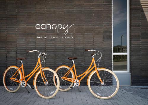 three bikes parked in front of a brick building at Canopy By Hilton Dallas Frisco Station in Frisco