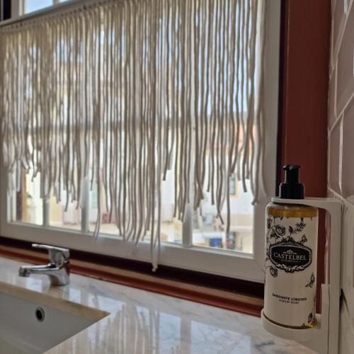 a bottle of soap sitting next to a window at CASAS de CONSTÂNCIA in Constância
